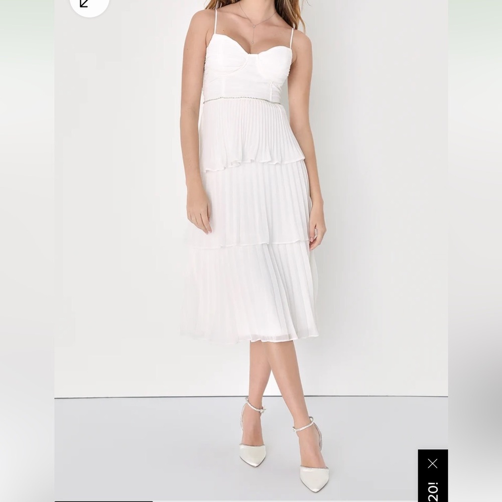 Lulu’s white pleated tiered midi dress with rhinestone detail.